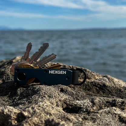 NexGen KeyCase Navy Blue on a sea stone overlooking the ocean